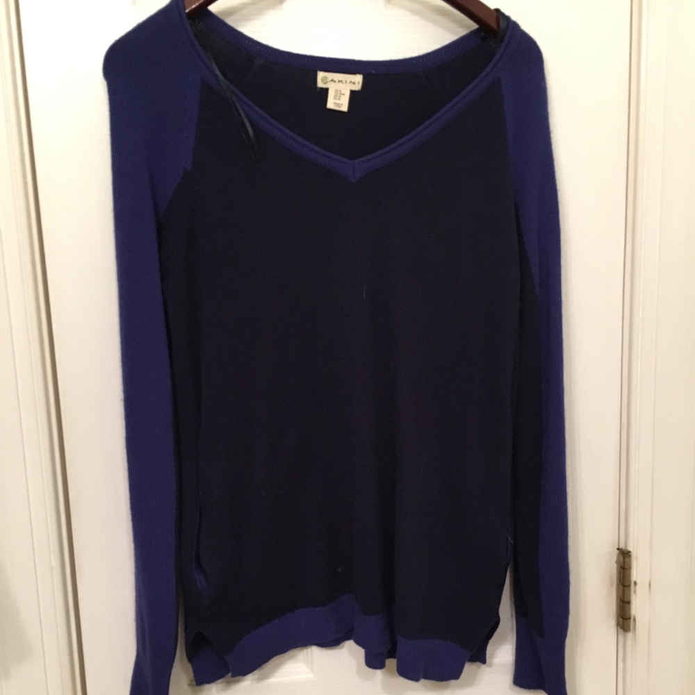 A dark blue/ purple sweater with pockets